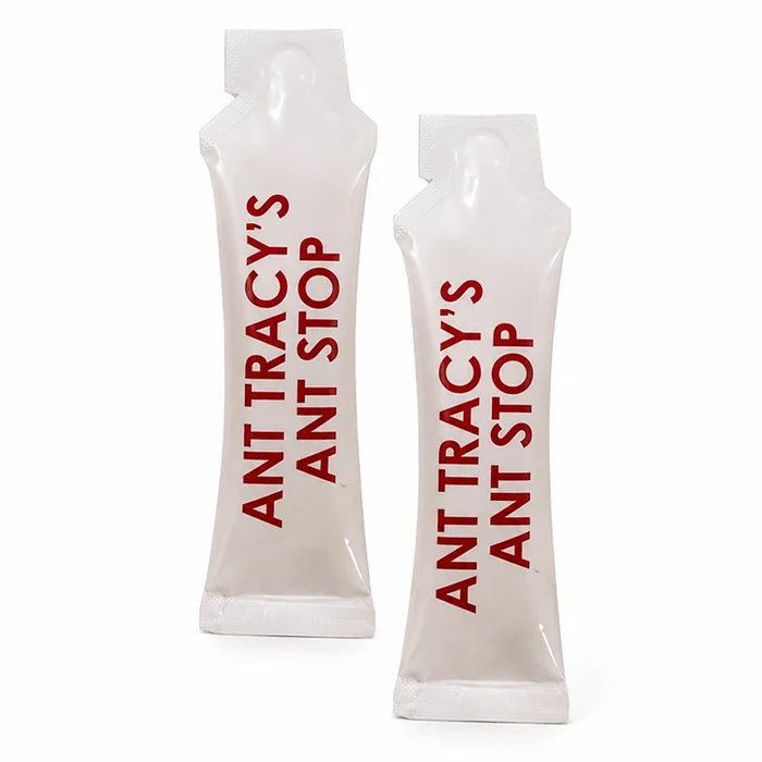 Two refill packets of Ant Tracy's Ant Stop ant barrier treatment standing upright on a white background.