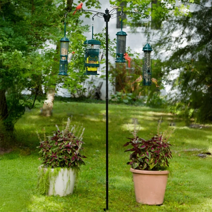 Bird feeder stand with multiple bird feeders in a garden setting