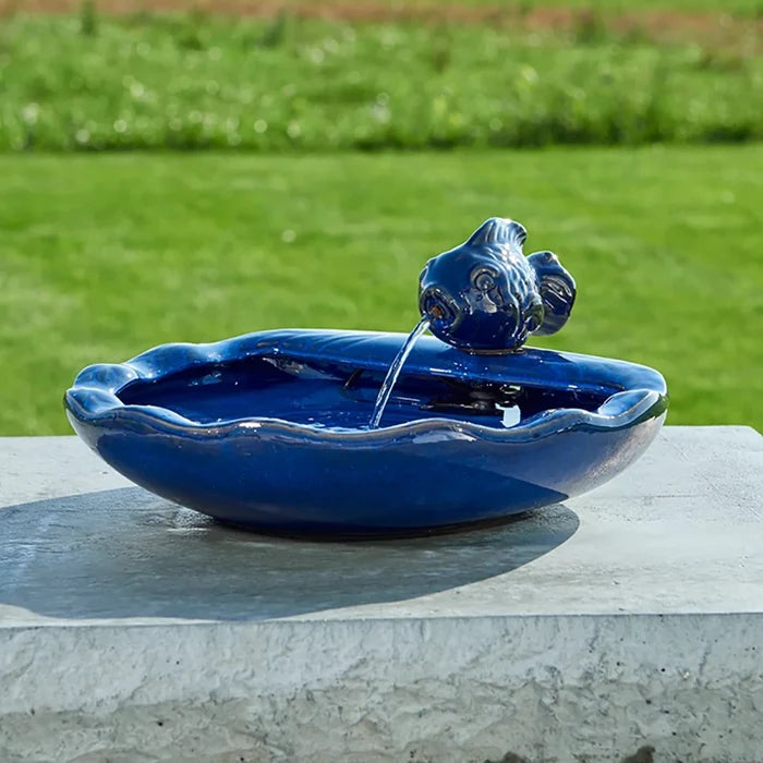 Ceramic Koi Solar Fountain with a koi spout in a scalloped bowl, recycling water to create a soothing garden ambiance.