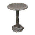 Decorative metal bird bath on a white background