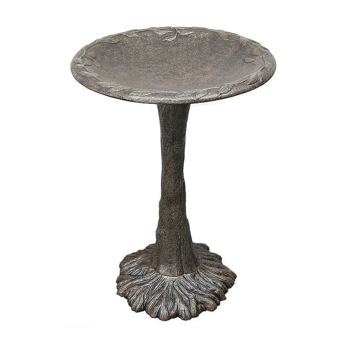 Decorative metal bird bath on a white background