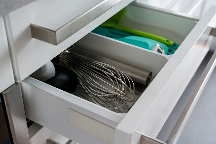 Kitchen drawer organiser with utensils