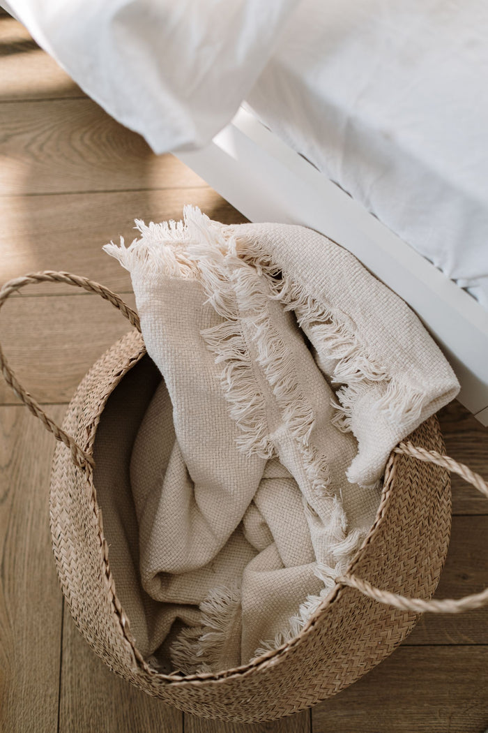 Seagrass floor basket with a soft fringed rim