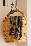 Woven wall basket hanging from a hook