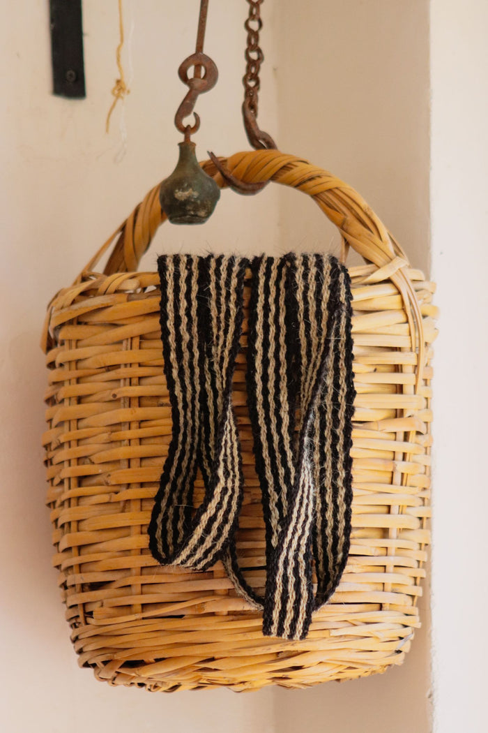 Woven wall basket hanging from a hook