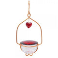 Holland Hill Heart Hummingbird Feeder with cherry red glass lid, heart-shaped copper wire frame, and clear dish, featuring 4 feeding ports and a copper hanging hook.