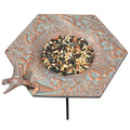 Hummingbird Garden Bird Feeder with bird food, hand-cast metal design featuring a hummingbird, wide rim, copper verdi finish, and metal stake for easy installation.