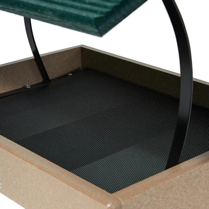 Close-up of a platform bird feeder with a mesh floor and metal frame.