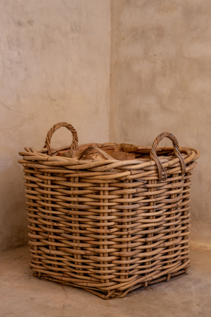 Large woven wicker basket with cut-in side handles