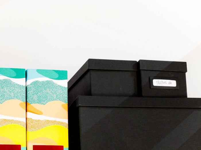 Lidded storage boxes with metal label holders