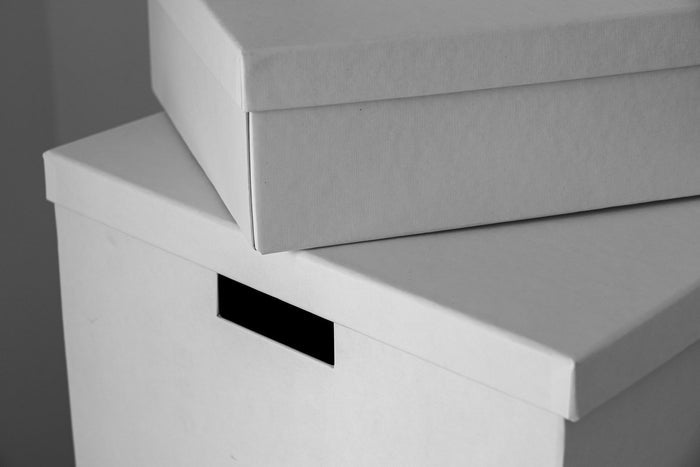 Stacked white storage box with a label holder