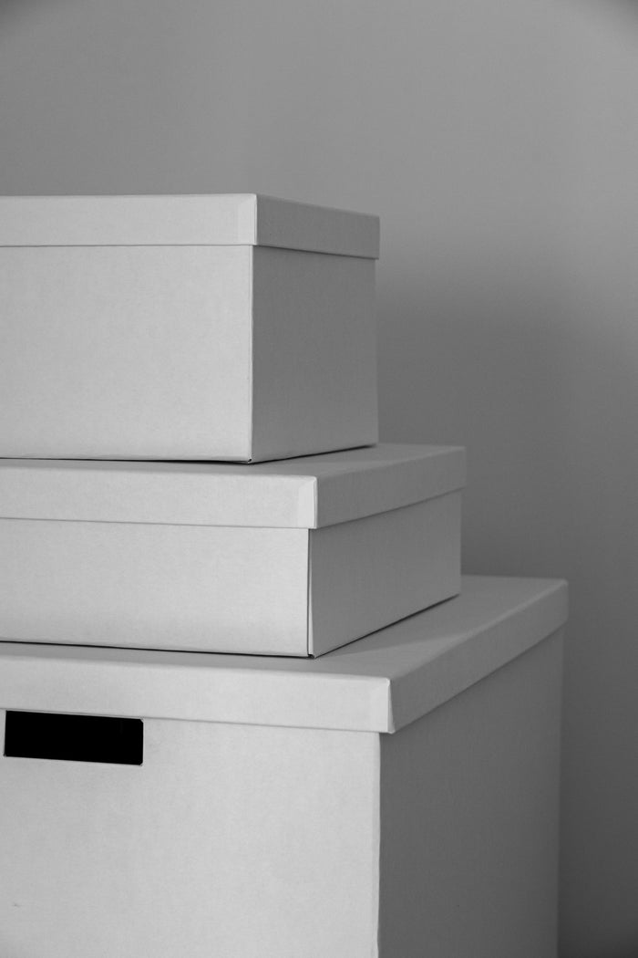 Nested white lidded storage boxes