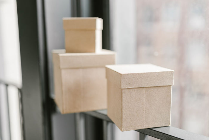 Two pale wooden storage boxes on a shelf