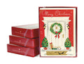 Three stacked boxed card sets next to a front facing boxed card set of the Merry Christmas Home Card showing a front porch decorated for the holidays.