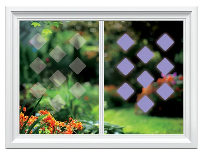 Window with decorative film showing a geometric pattern with purple shapes, set against a blurred garden background.