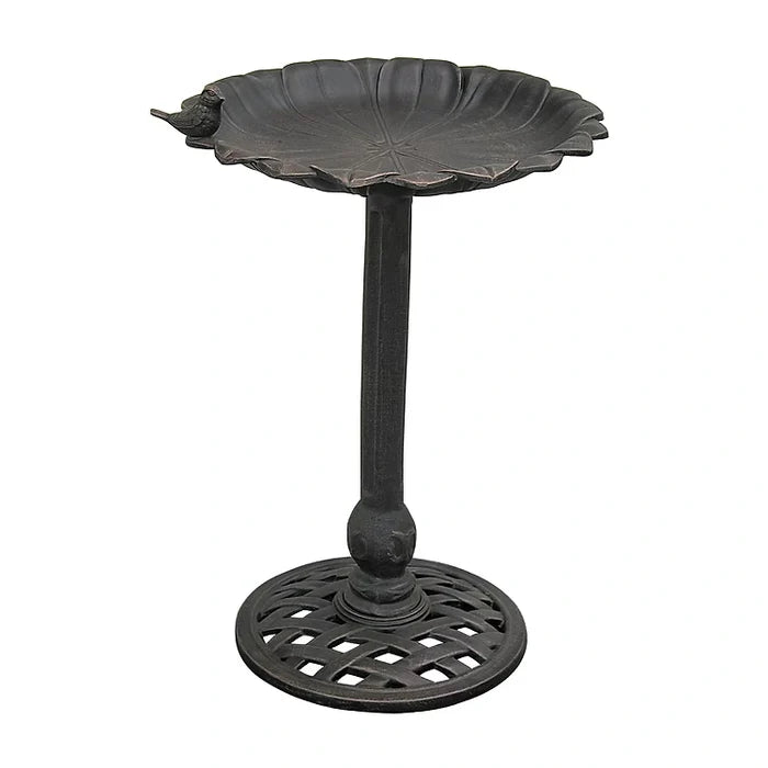 Black metal bird bath on a white background