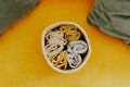 Small round jute rope basket holding folded cloths