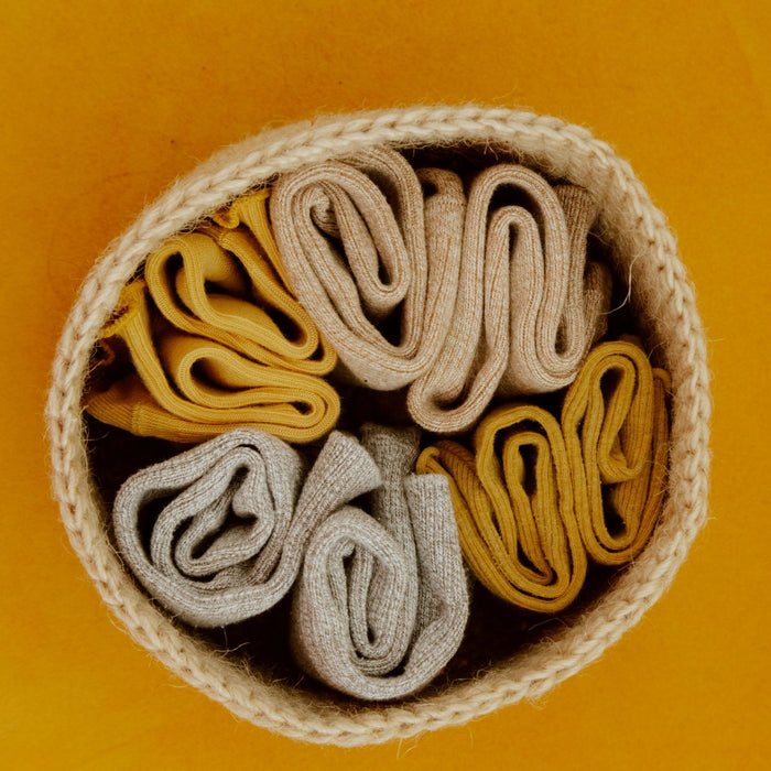 Jute basket filled with rolled flannels seen from above