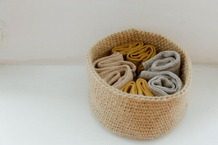 Small jute basket on a pale wooden floor