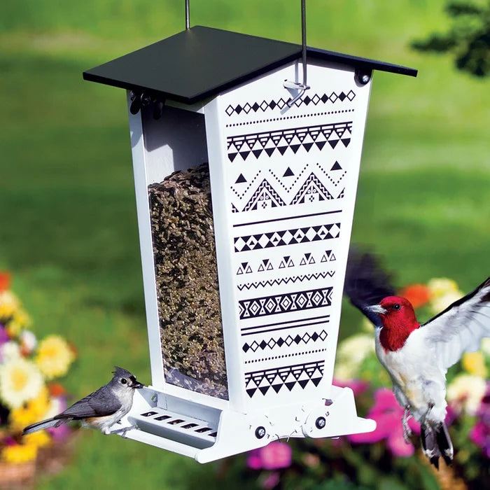 Snack Shack Nordic Habitat Squirrel-Resistant Feeder with white metal, black trim, and two birds feeding. Features squirrel-proof design and weight-activated perches.