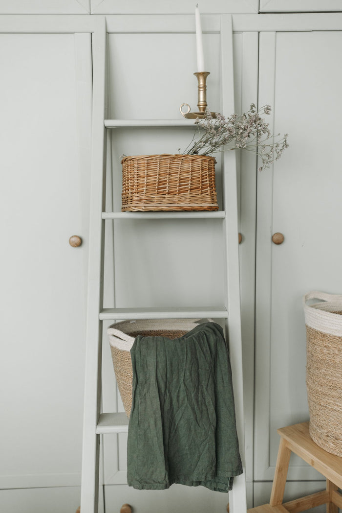 Wardrobe with woven storage baskets on the shelf