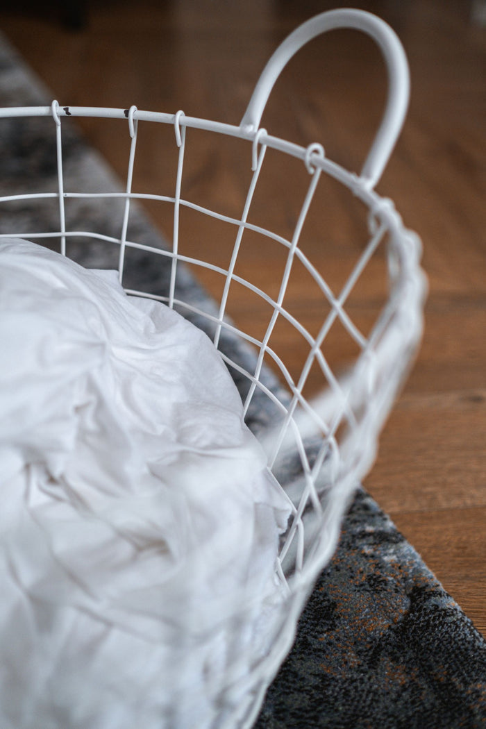 Mesh laundry basket filled with washing